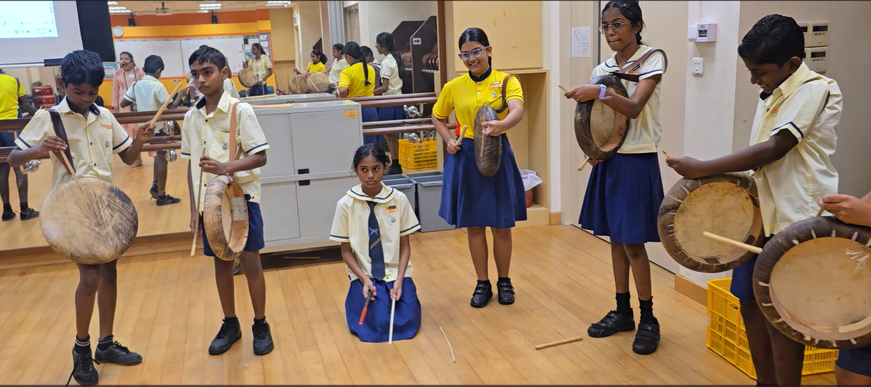 Students with traditional Indian instruments learning how to drum